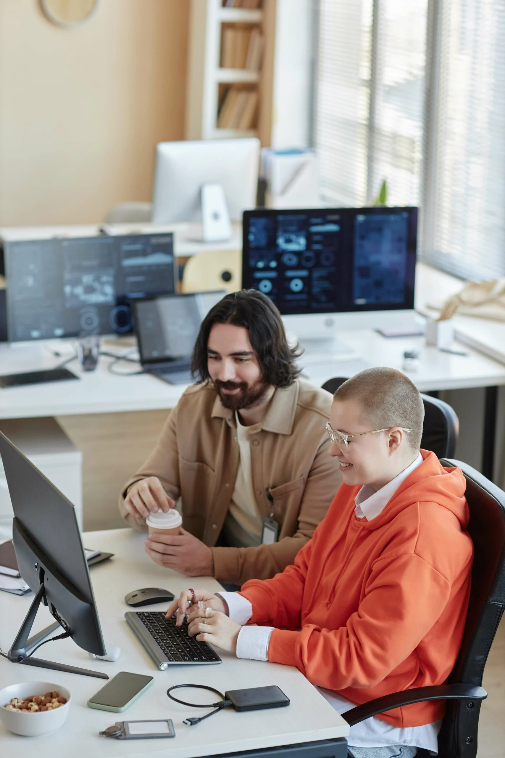 Young Female It Manager And Her Male Colleague With Cup Of Coffee Young Female It Manager And Her Male Colleague With Cup Of Coffee